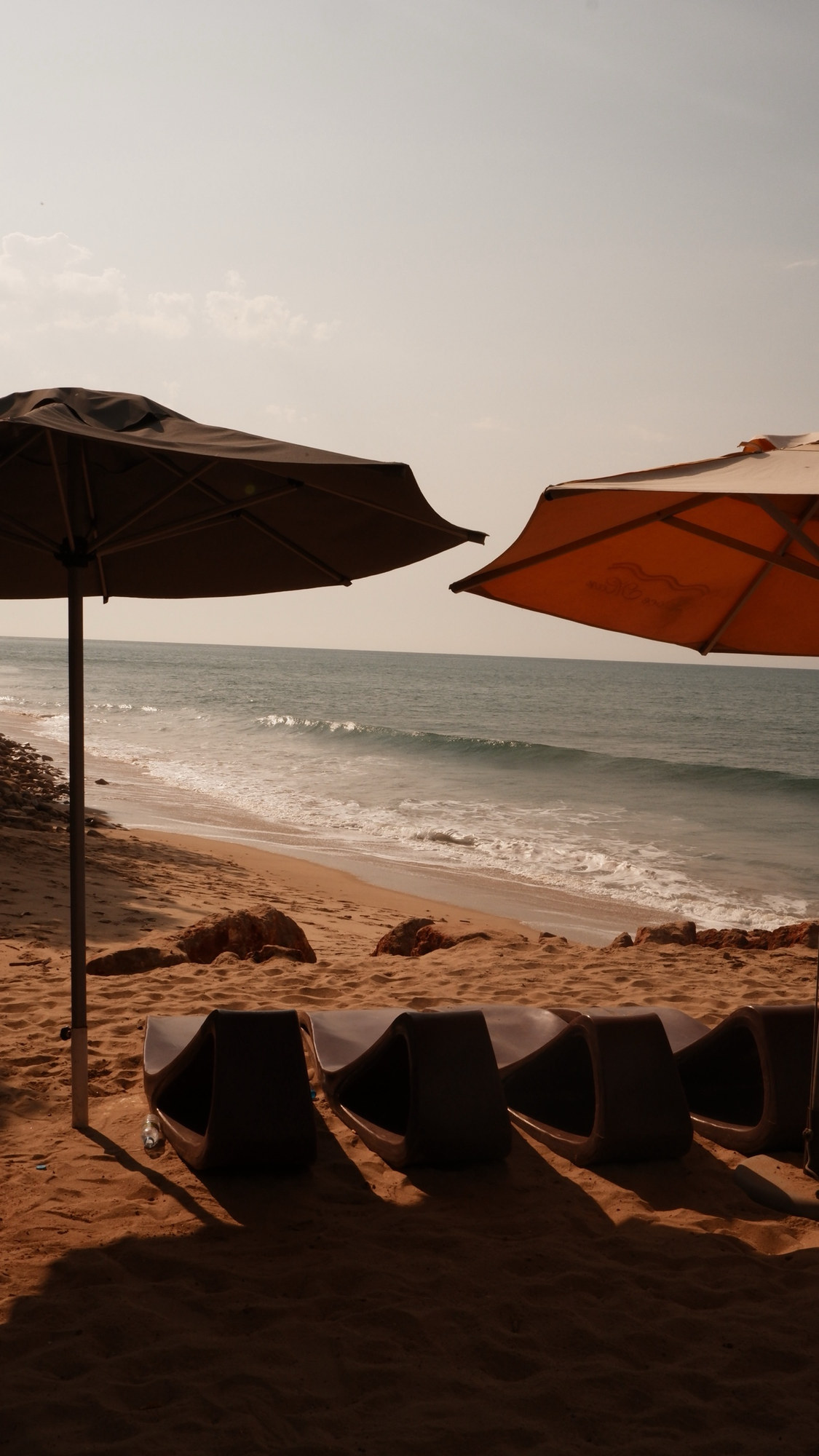 Two beach umbrellas framing the sea